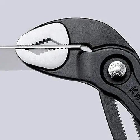 Close-up of Cobra Water Pump Pliers 7 And A Quarter Inch Beefy Self Locking Pliers With Teeth Grip on metal object