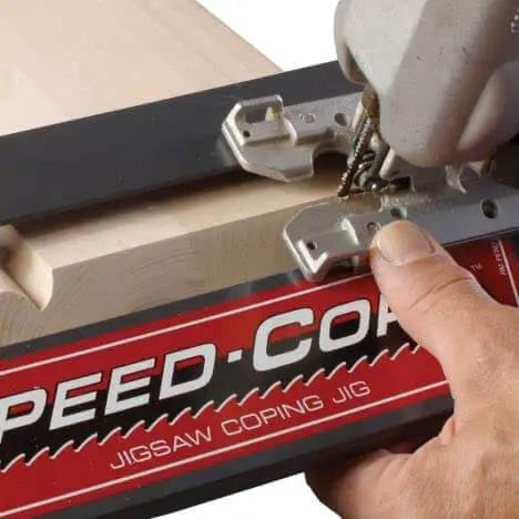 Speed Cope Crown Molding Jig With Adjustable Handle For DIY Woodworking in use with jigsaw making precise cope cuts.