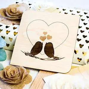 Laser-engraved Baltic Birch Plywood with two birds inside a heart, 12x12 inches, AA grade natural veneer color, 1/8 inch thick.
