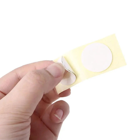 Hand holding 3M adhesive pad for Stick On Waterproof Digital Thermometer For Motorcycles