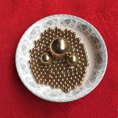 4mm 200pcs Solid Pure Copper Balls - Brass Ball Bead arranged in a decorative dish on red fabric