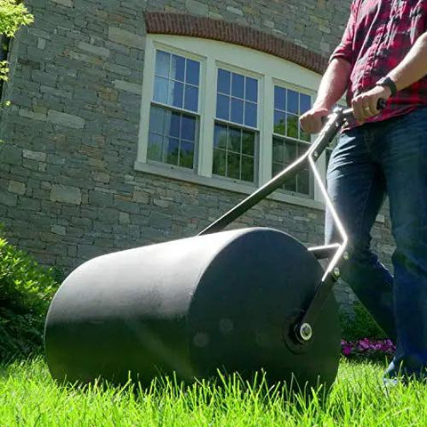 Person using Powerful 270 Lb Poly Lawn Roller For Push Or Tow With Easy Turn Tethered Plug And Quick Filling Drum 18 By 24 Inches