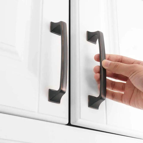 Oil Rubbed Bronze 5 Inch Cabinet Pulls Pack Of 10 Solid Metal Contemporary Big Square Arch Handles being installed on white cabinets.