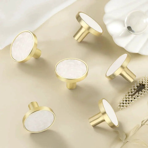 Gold and white round cabinet knobs on beige background, suitable for 12 Pack White Cabinet Knobs For Kitchen Cabinets And Dresser Drawers Drawer Pulls Easy Install Replacement Hardware Durable Smooth Finish Premium Quality Knobs For Home Renovation For Home Improvement
