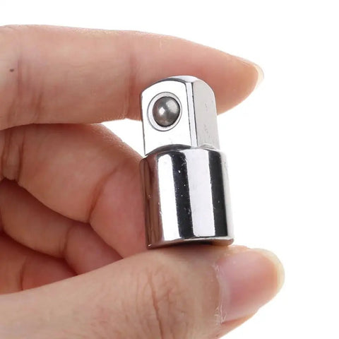 Socket adapter close-up: chrome 3/8-inch head with detent ball, held between fingers.