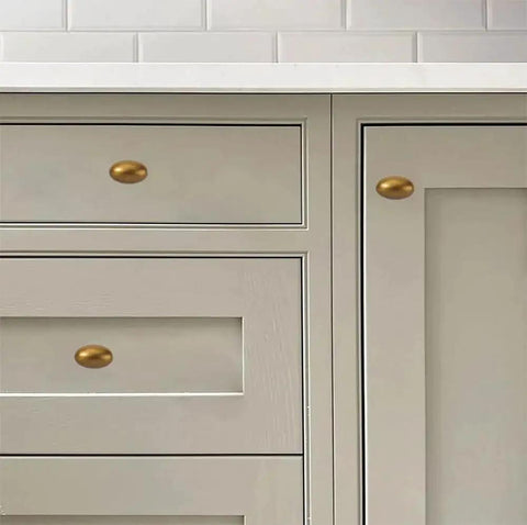 Antique Brass Cabinet Knobs 10 Pack 1-3/8 Inch Oval Drawer Knobs for cabinets and drawers, installed in kitchen setting