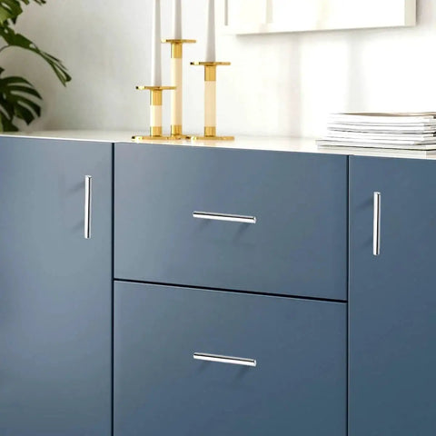 Close-up of polished chrome T bar cabinet pulls 256mm hole centers 10 inch center to center on blue kitchen cabinets