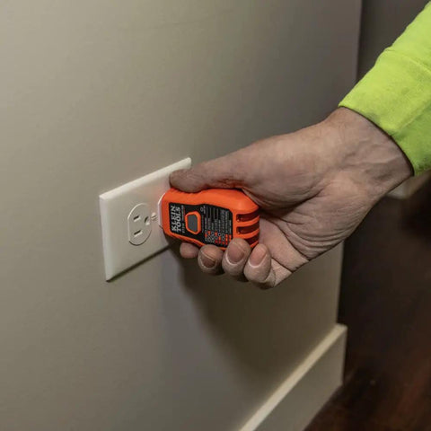 Person using the ET310 receiver for testing a GFCI outlet as part of the Fast Circuit Breaker Finder Kit For Quick Panel ID And Safe Wiring, ET310 Receiver With GFCI Outlet Tester, 69411 Companion, 2 Piece Set By Klein Tools.