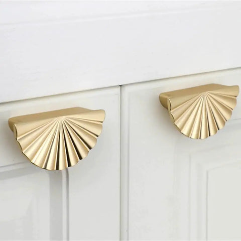 Semicircle Sunflower Cabinet Pulls In Brushed Gold Finish 6 Pack installed on white cabinets