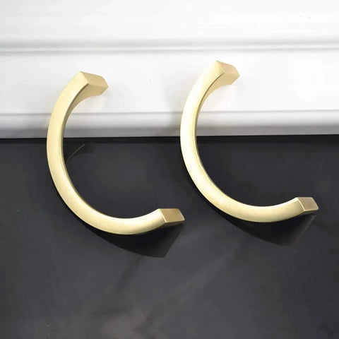 Two Pair Cabinet Hardware Handles In Golden Copper Brushed Gold Finish With Double Hole Mounting displayed on black surface