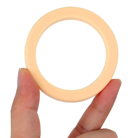 Hand holding a 54mm Silicone Steam Ring Replacement Gasket Kit No BPA 5 Pack For 54mm Grouphead Espresso Machines.