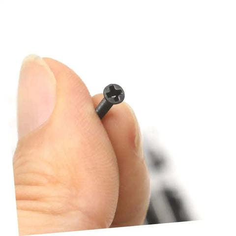 Close-up of a flat-head screw from the Miniature Screw Set With 18 Sizes, held by fingers, showing detail and texture.
