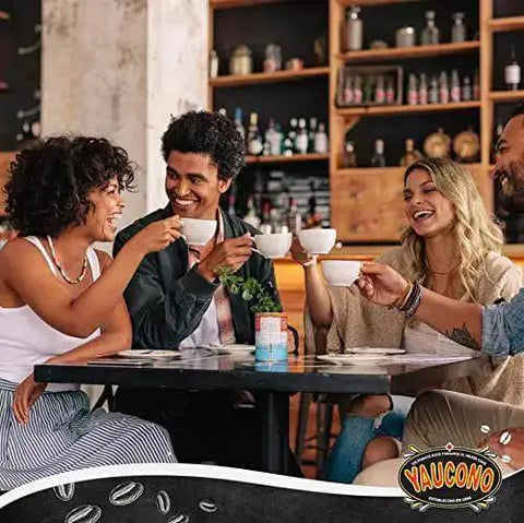 Group of friends enjoying coffee at a cafe, holding cups and smiling, seated at a wooden table with a coffee-themed decor backdrop.