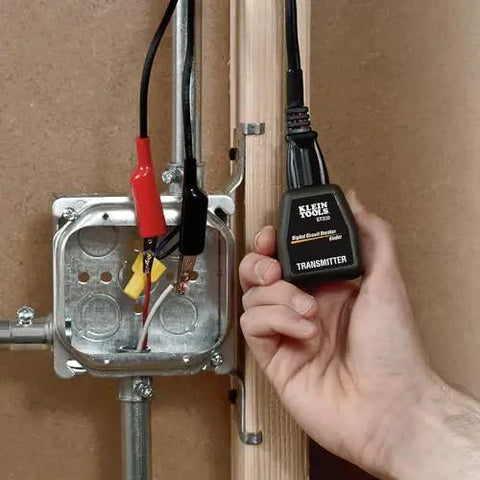 Fast Circuit Breaker Finder Kit For Quick Panel ID And Safe Wiring, ET310 Receiver With GFCI Outlet Tester, 69411 Companion, 2 Piece Set By Klein Tools transmitter held near electrical box with wires.