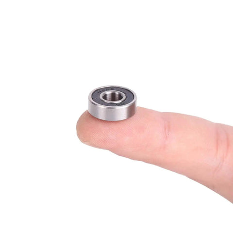 R4 2RS Ball Bearings For Motors And Wheels From Donepart on fingertip, showcasing small size, double sealed design, ideal for motor applications