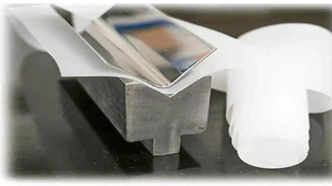 Close-up of 4 Inch By Point Zero One Five Inch By 100 Foot Urethane Die Protection Film for press brake on metal surface