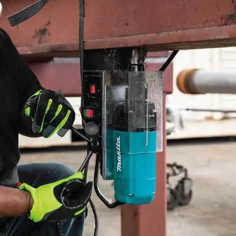 Image showing Portable Magnetic Drill For Steel With One And Three Eighths Inch Capacity And Two Inch Thick Cutting, A Real Workhorse With 850 RPM From A Ten Amp Motor, Lightweight And Compact For Tight Spaces attached to a steel beam in use.