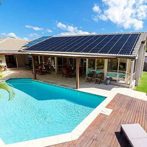 House with solar panels and swimming pool, illustrating solar equipment compatibility for pool systems.