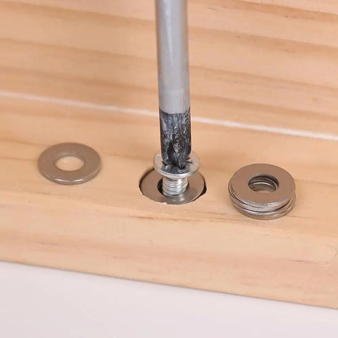 Close-up of 180 Piece Stainless Steel Flat Washer Set M2 To M10 For Fastening DIY Repairs Gasket Spacers on wooden surface