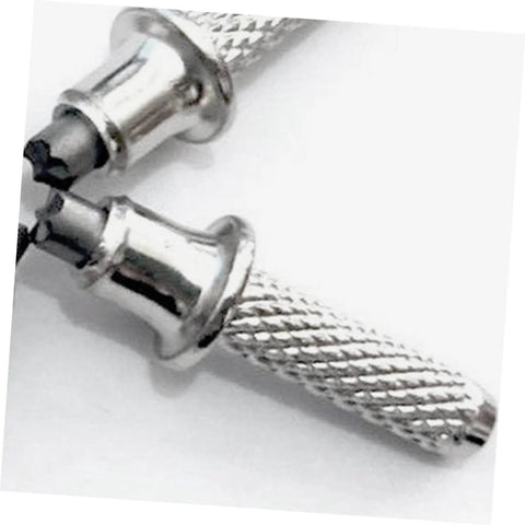 Close-up of silver trekking pole tips, metal construction, fits most hiking poles, offers stable grip on rough terrain and trails.