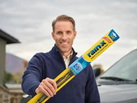 Man holding WeatherBeater 22 Inch Wiper Blades Pack of 2 With OEM Quality Durability in parking lot