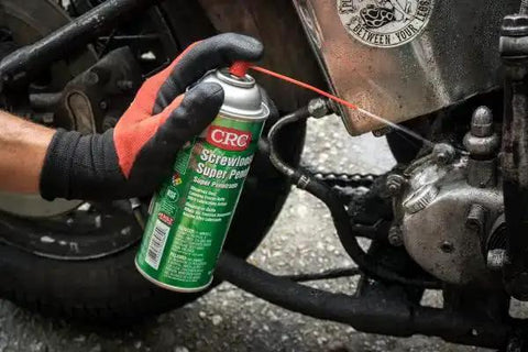 Person using Super Penetrant Aerosol For Corroded Fasteners And Seized Mechanical Components Plastic Safe Formula Fast Acting Rust Release
