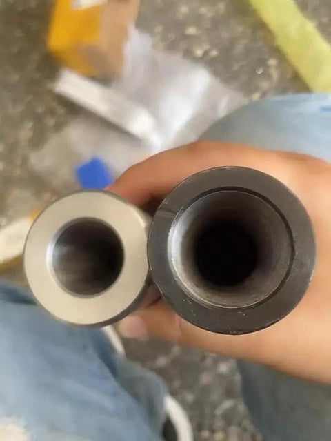 Front view of two metal Morse taper reducing sleeves (gray and black) with hollow bores