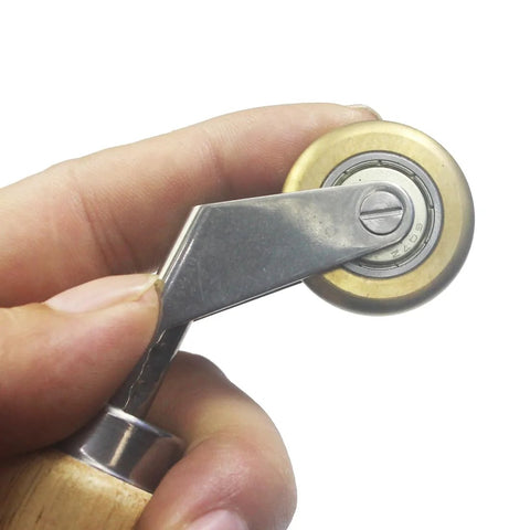 Seam roller with a 40mm silicone wheel and brass detail, handheld roofing tape tool