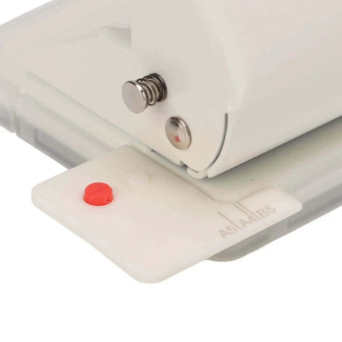 Close-up of Heavy Duty Metal Hole Punch For Home Office Desk, 10 Hole Punch That Punches Up To 10 Sheets, in White with positioning guides