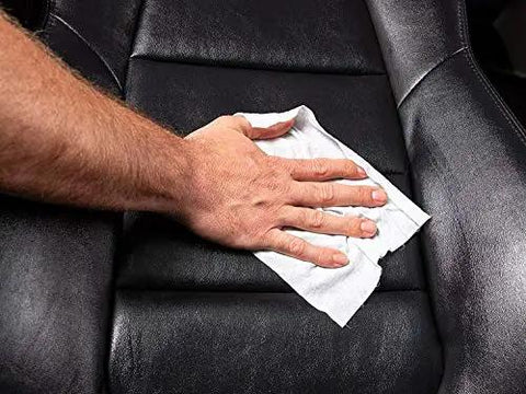 A hand using a Gold Class Rich Leather Wipes For Car Care With Conditioning And UV Protection, Moisturizers Help Prevent Drying Out And Cracking, 30 Count By Meguiar's on a leather car seat.