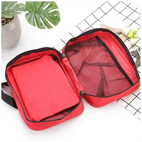 Open Compact Red First Aid Bag For Emergency Medical Supplies With An Organized Interior And Multiple Pockets on table
