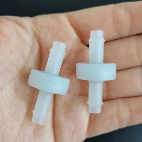 Two white PVDF one-way check valves with barb fittings for spa ozone system