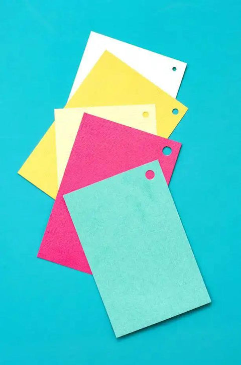 Colored paper sheets with holes made by Multi Size Hole Punch For Leather, Paper, Fabric And More Rotates Through Five Hole Sizes