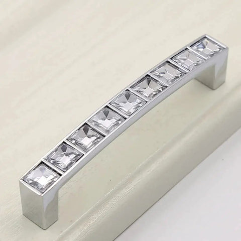 Close-up of Six Pack U Shape Crystal Glass Drawer Pull Knob with shiny silver handle and zinc alloy base on cabinet.