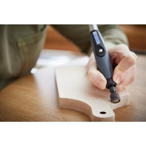 Person using Flex Shaft Rotary Tool Attachment With Comfort Grip And 36 Inch Cable for precise wood carving on a cutting board.