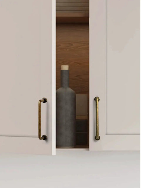 10 Pack Antique Brass Cabinet Bar Pulls 3 Inch Center To Center for kitchen cupboard with open doors showing bottle.