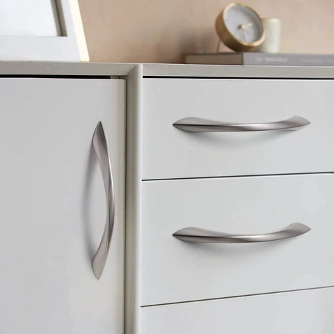 10 Pack Brushed Nickel Cabinet Pulls 5 Inch Arch Twisted Silver Handles installed on white drawers and cupboards