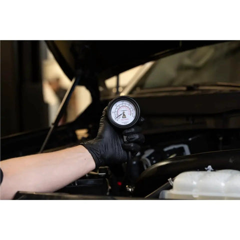 Mechanic using Engine Compression Test Kit With 2.75in Gauge And Quick Disconnect Adapters on car engine