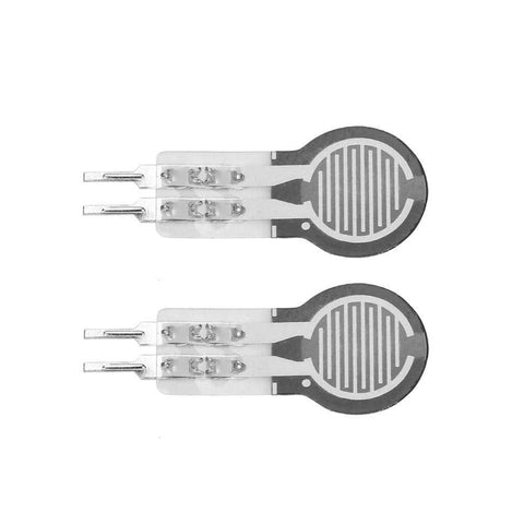 Two DF9-16 thin-film force-sensing resistors, round black discs with white interdigitated traces and dual leads