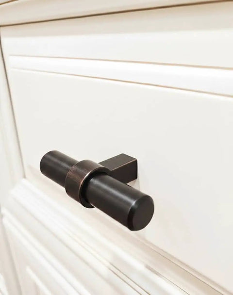 Oil Rubbed Bronze Cabinet Bar Pulls 10 Pack Two And Three Eighths Inch Long One Half Inch Bar Diameter One And Five Sixteenths Inch Projection Includes Mounting Screws Solid Steel Cosmas 181ORB installed on white cabinet