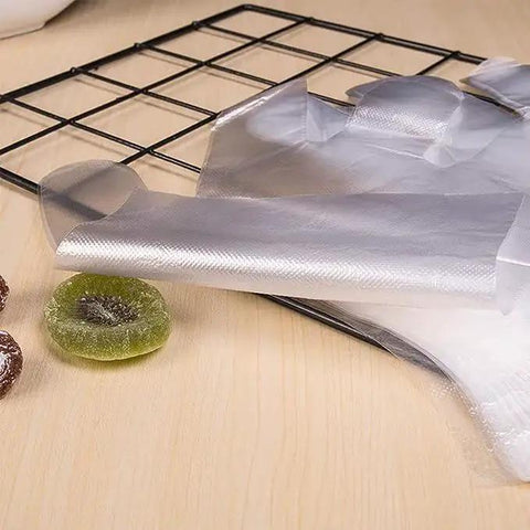 Clear Plastic Disposable Gloves For Food Prep And Service Bulk 6000 Pcs on table with fruit