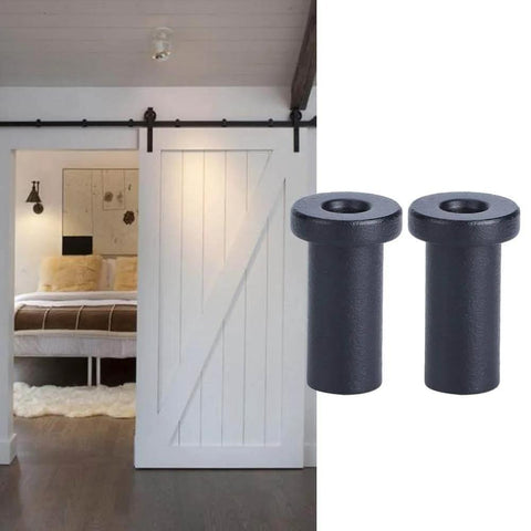 Built Tough Bottom Spacers For Sliding Barn Doors, Matte Black Wall Spacers With Door Shaft Pins, shown installed on a white barn door