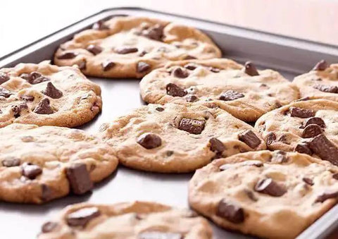 Chocolate chip cookies on Commercial Grade Aluminum Sheet Pan With Large Flat Baking Surface Two Thirds Size 18 Gauge Reinforced Rim Closed Bead Rust And Corrosion Resistant Heavy Duty Bakeware For Cookies Roasted Veggies And Desserts.