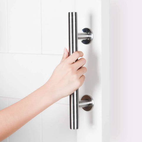 Hand gripping a Two Pack 12 Inch Sliding Barn Door Handle Set, Heavy Duty Stainless Steel Flush Pull Hardware on a white door.