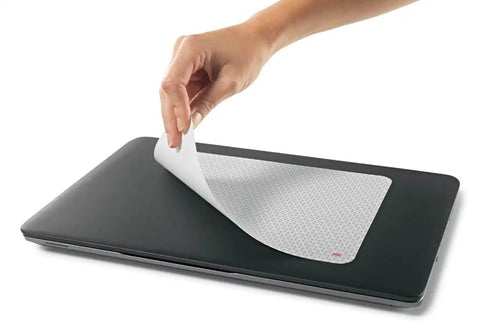 Precise Mouse Pad With Repositionable Adhesive Back For Optical Mice At High Speeds shown being applied to a laptop.