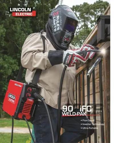 Man welding a fence using 90i FC Flux Core Wire Feed Welder Weld-Pak Portable 120V Welding Machine With Shoulder Strap And Protective Metal Case