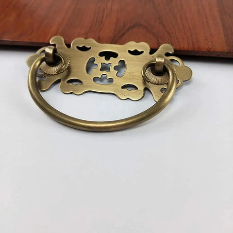 Antique Brass Vintage Style Pull Handles Set for Bookcases and Wardrobes, shown installed on 22mm wood drawer
