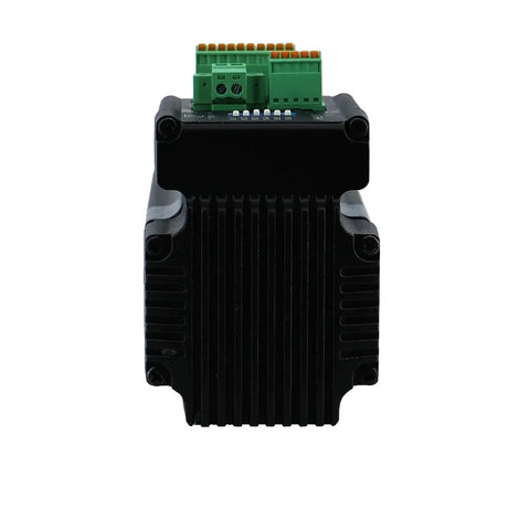 Front view of Nema23 integrated stepper motor with driver, black finned housing and green terminal block on top.