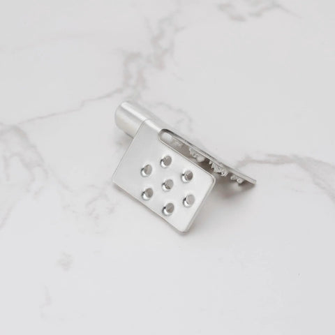 Front view of a silver metal crimp connector mounting clamp with a perforated plate