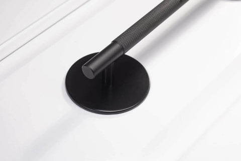 Close-up of a Matte Black Escutcheon Back Plate For Cabinet Knobs And Doors, installed with a handle, showing the round rosette plate.